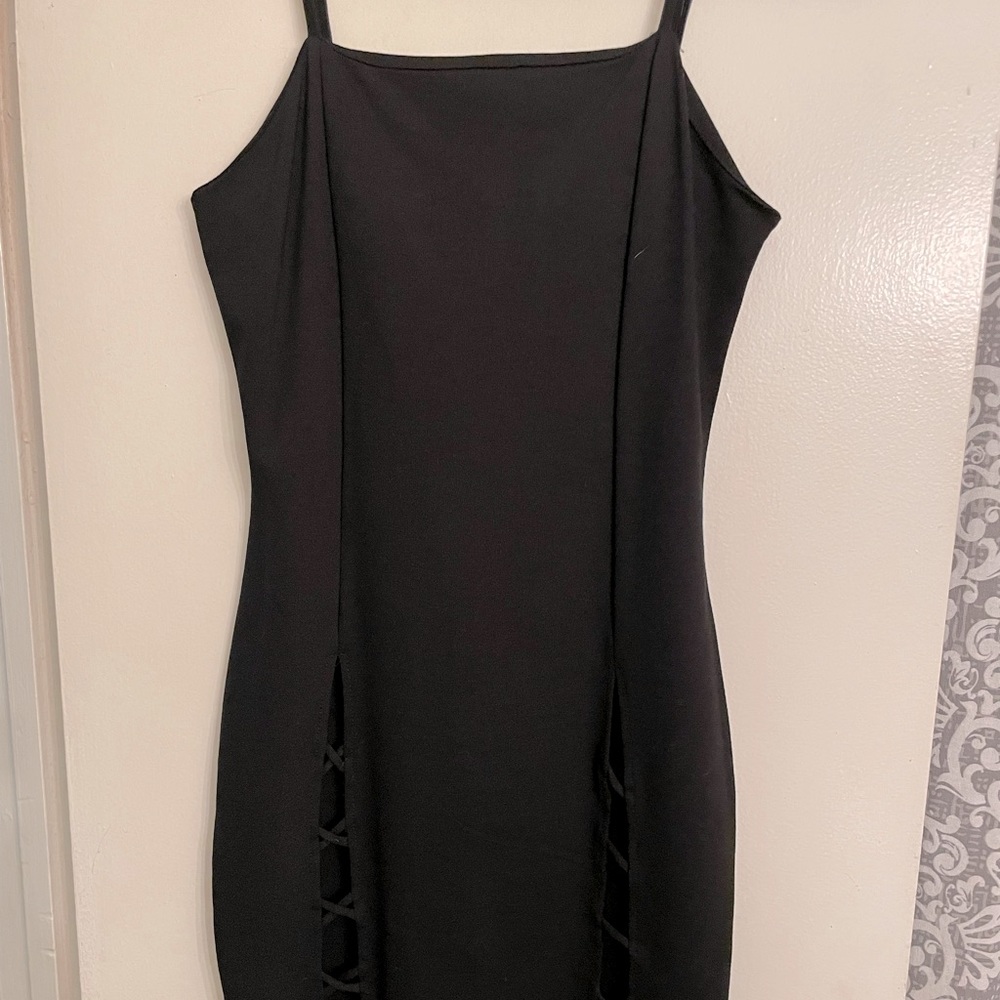 Little black dress with strappy details below waist .Size Medium .Brand new !!